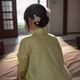 金沙国际用户张女士头像，年轻女性侧脸照，背景模糊室内环境